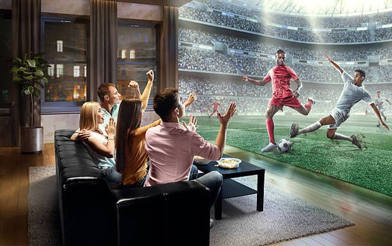Students watching very realistic Soccer game on TV