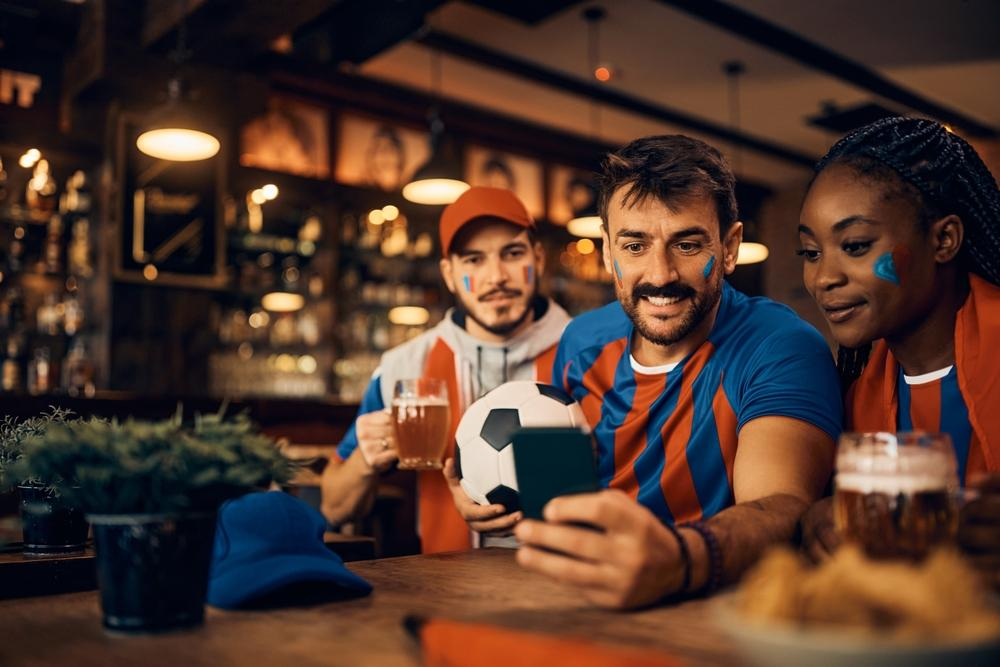 Sports fan and his friends watching football match