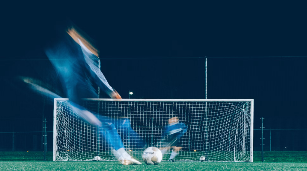 soccer player kicking ball